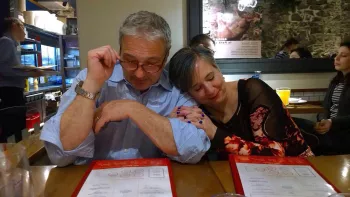 Athena's Father Deno and his wife Jeanine at lunch sharing a sweet embrace