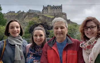 Athena Bogdanos and family in front of a castle on a hill