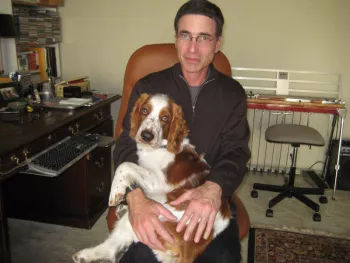 Man holding a beagle in his lap