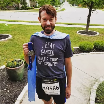 Chris Hartley wearing a "I beat cancer what's your superpower tshirt"