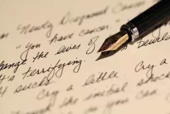 A hand-written letter and ink pen