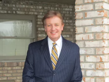 A man dressed up in a navy suit