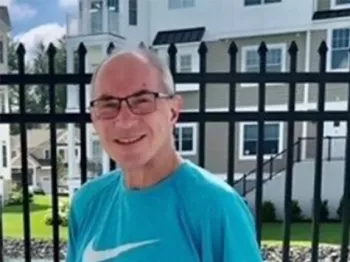 Jason Wrency standing in front of a fence