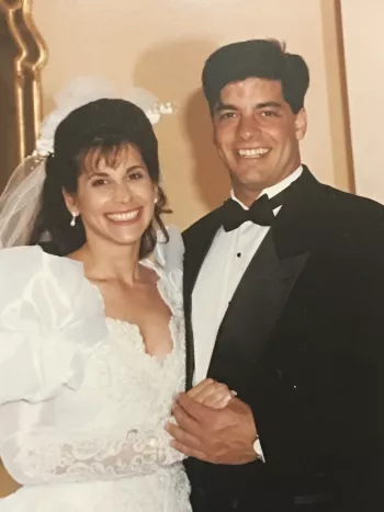 Caucasian bride and groom posing for a photo at their wedding