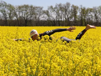 Tyler Myers going for a swim through a field of flowers decked out in full swim garb and cap