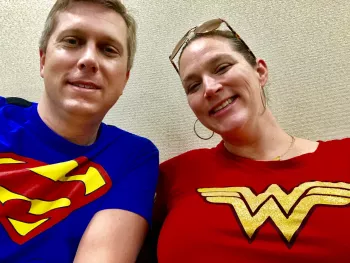 Tyler Myers post op wearing his Superman shirt and his wife wearing her Wonder Woman