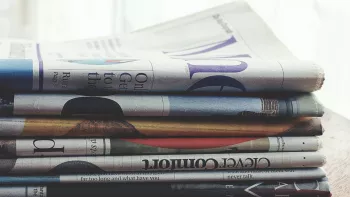 Newspapers stacked on top of one another