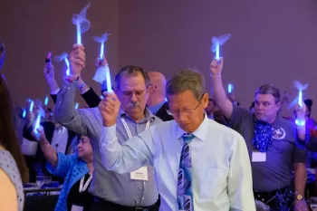 Randy and the crowd holding up blue lights to honor Prostate Cancer patients