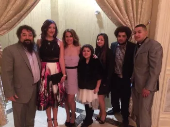 Anna and her husband Joe and family well dressed and posed for a picture