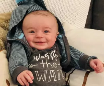 Jimmy Charles' baby smiling at the camera