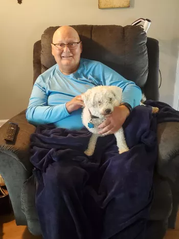 Dale Golgart and his dog Tucker all tucked in to their leather recliner
