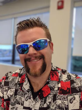 Paul Devlin rocking a nice beard for Grow and Give paired with a sporty set of shades