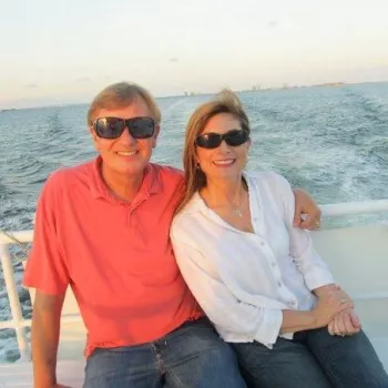 Glenn and Mrs. Mollette on a boat wearing sunglasses close to sunset