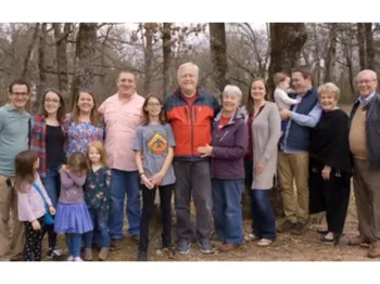 A large group stands for a family photo