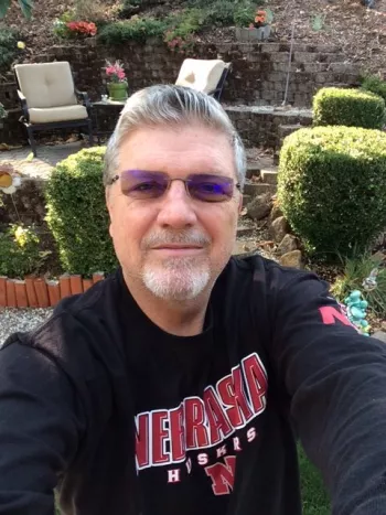 Jon Albrecht taking a selfie in a lovely garden