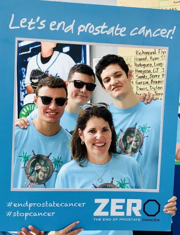 Group of people holding up a Let's end prostate cancer selfie cutout