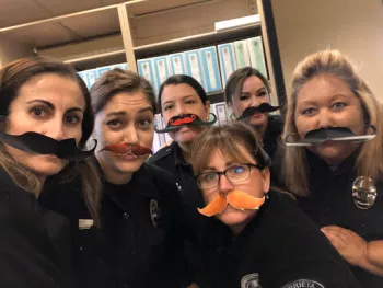 Murrietta Police Department female police officers wearing fake mustaches in support of Grow & Give campaign