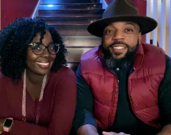 Before it all started, Mical Roy and his wife sitting on the stairs