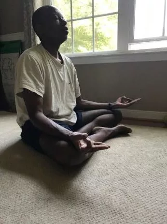 Thomas Addison meditating to promote a healthy mind, body balance