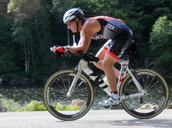 Tom Hulsey riding an IRONMAN  on his road bicycle donned in full sport gear