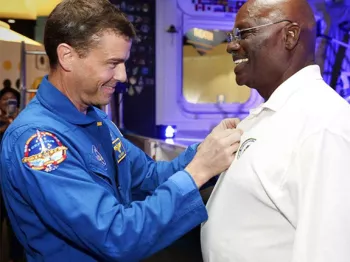 Victor Murray accepting a NASA award from an astronaut