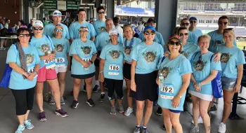 Team Lovey group photo wearing matching seafom blue shirts