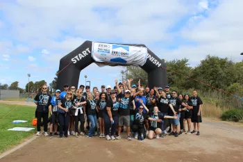 People posing in front of ZERO Run/Walk start line