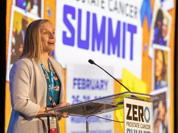 A blonde woman, Shelby Moneer, standing at a podium during the ZERO Summit 2023