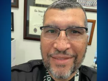 Man smiling at camera in black shirt 