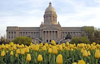 The state of Kentucky Capitol building with yellow tulips in front of it