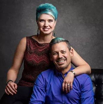 Brandy and Leo Nunes sitting on a black couch