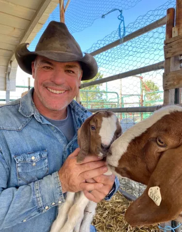Cowboy Max and Baby goat with a big goat