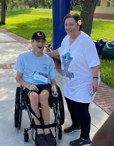 A man in a wheelchair and a woman standing next to him