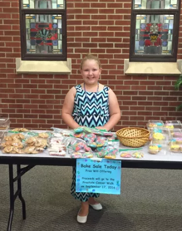 Young girl hosting a bake sale