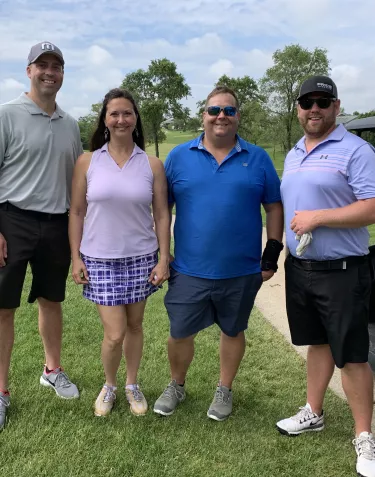 A group of people with a golfing gear