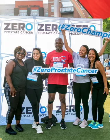 A group of African Americans at a ZERO Prostate Cancer RunWalk in front of a Champions banner