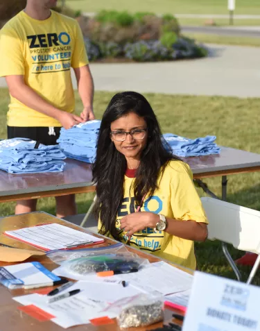 Volunteers in yellow t-shirts supporting a ZERO stand