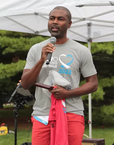 African American man wearing sports clothes and giving a speech
