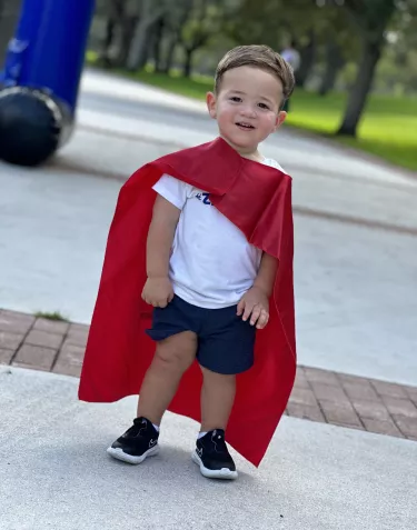 Kid with a superhero cape