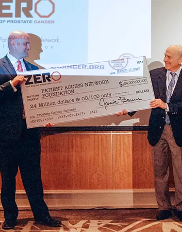 Jamie Bearse presenting a large check to Patient Access Network Foundation