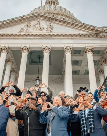 Jamie Bearse and large group of advocates on the steps of Capitol Hill
