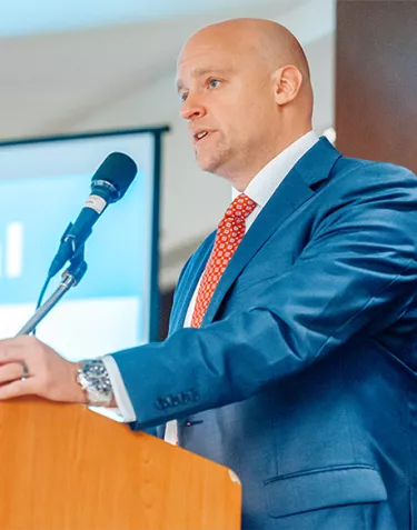 Jamie Bearse speaking at a podium in 2017