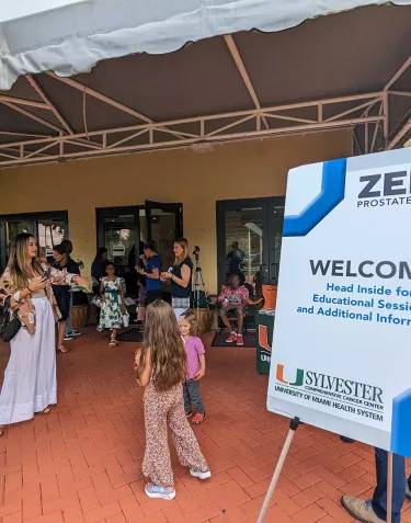 A ZERO welcome sign at the 2023 Education event in Miami with people surrounding it