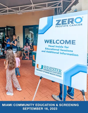 A sign on an easel that has the ZERO and University of Miami Sylvester Comprehensive Cancer Center logos. The text on the sign says "WELCOME. Head inside for educational sessions."