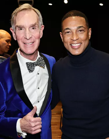 Two men, Bill Nye and Don Lemon, standing together smiling