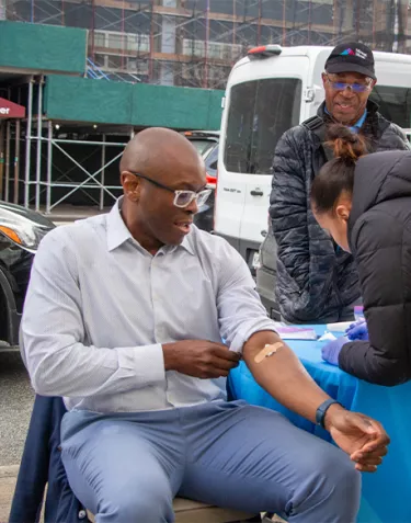 Black man with his sleeve rolled up