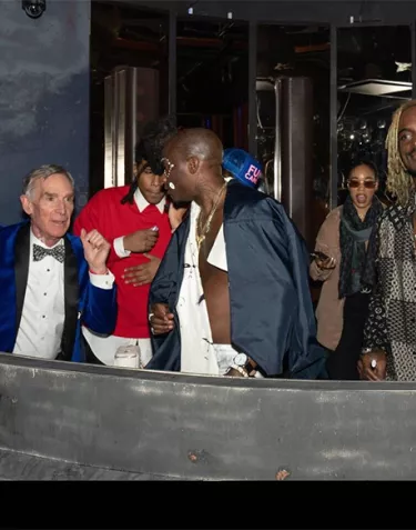 A group of people on a balcony at the 2023 Blue Jacket Fashion Show Afterparty