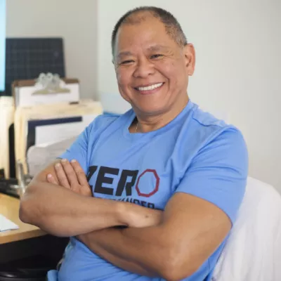 Middle aged Asian man in a blue ZERO t-shirt
