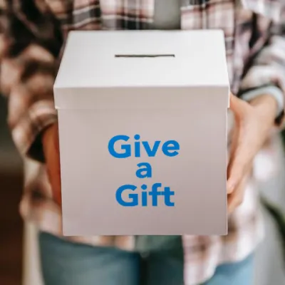 Man holding box that says 'Give a Gift'