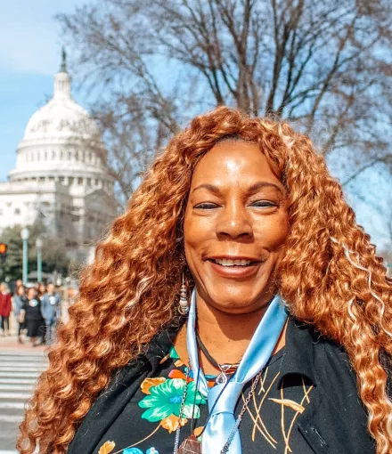 African American woman with long hair in front of the Capitol